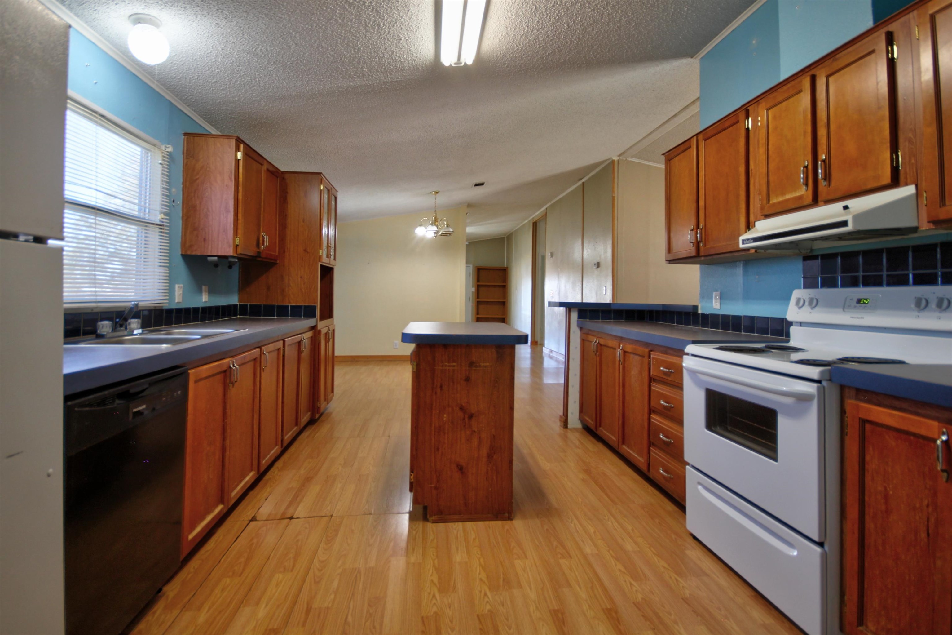 1504-2 Ranch Road 261 Buchanan Dam, TX 78609 - Photo 9 of 22 a kitchen with stainless steel appliances granite countertop wooden cabinets a stove top oven a sink and dishwasher