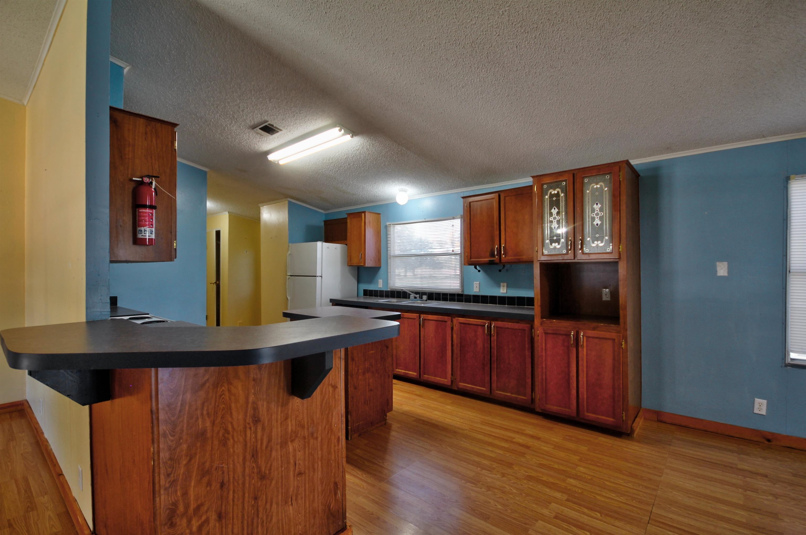 1504-2 Ranch Road 261 Buchanan Dam, TX 78609 - Photo 10 of 22 a kitchen with stainless steel appliances granite countertop a sink and wooden floor