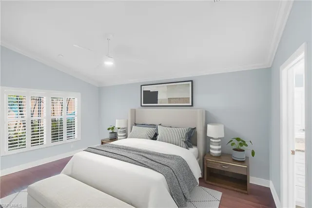 a bedroom with a bed and a couch with window