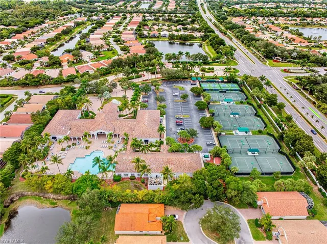 an aerial view of a house with a garden and lake view