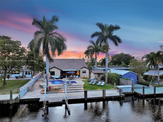 a view of a white house with a yard