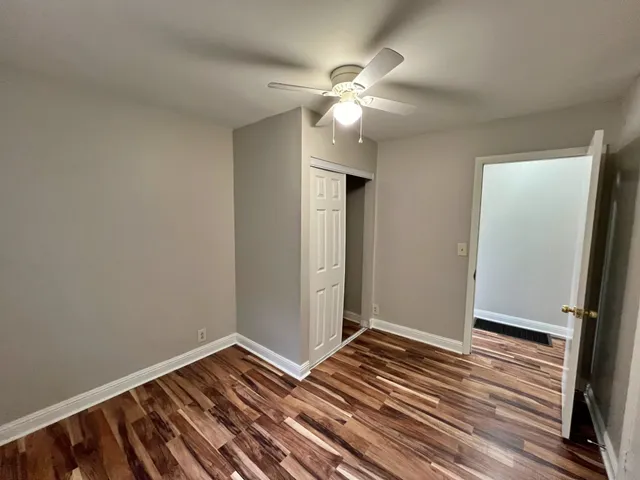 a view of a room with wooden floor