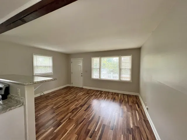 a view of wooden floor and windows in a room