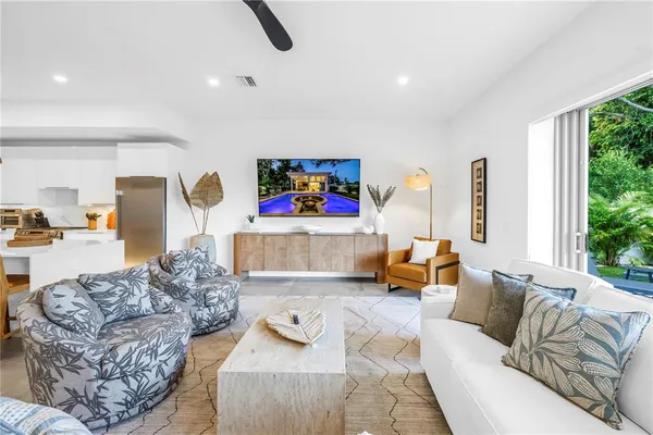 a living room with furniture and a large window