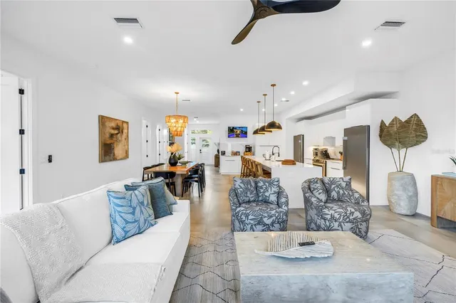 a living room with furniture and painting on the wall