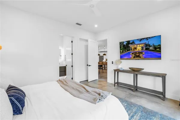 a bedroom with a bed a couch and a window