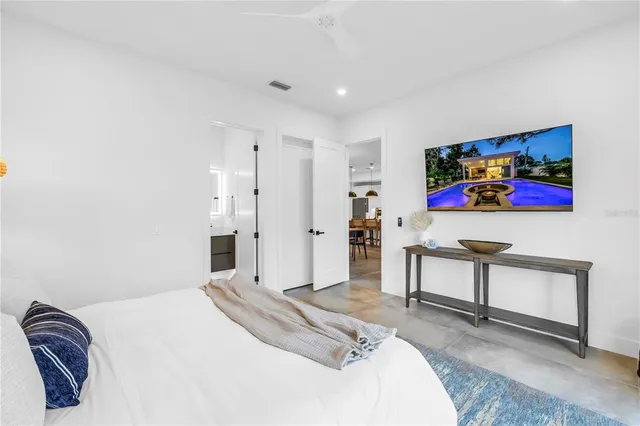 a bedroom with a bed a couch and a window