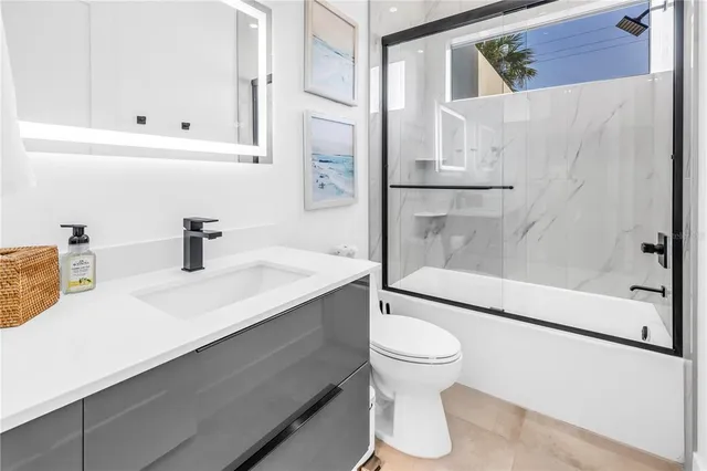 a bedroom with a large bed a rug and windows