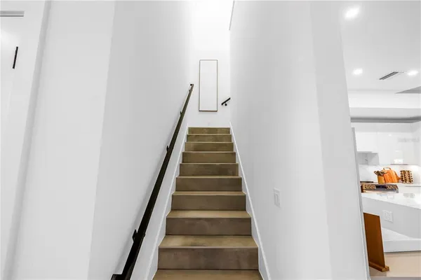 a bedroom with a bed and a chair