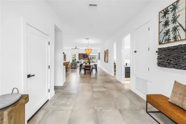 a view of a kitchen with kitchen island a stove a counter top a stove and a view of living room