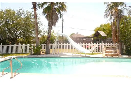 a living room with a couch and a potted plant