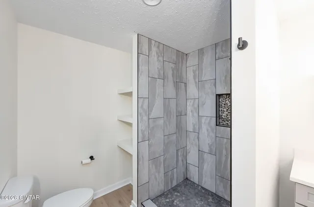 a bathroom with a shower and a toilet