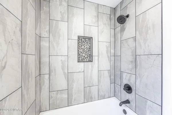 a bathroom with a shower and a shower