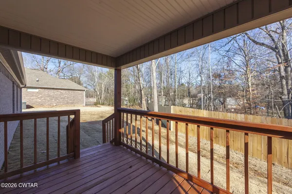 a view of a porch with wooden floor and outdoor space