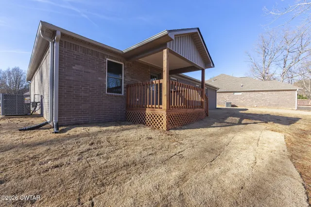 a view of a house with a yard and garage