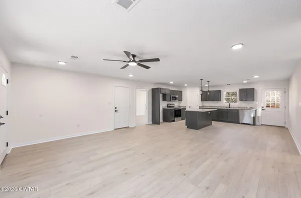a view of a kitchen with furniture and a ceiling fan