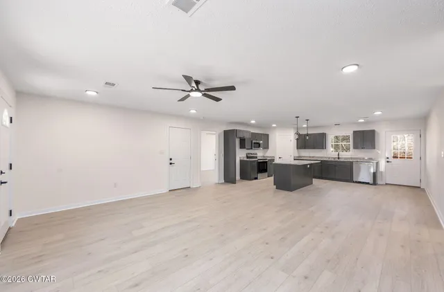 a view of a kitchen with furniture and a ceiling fan