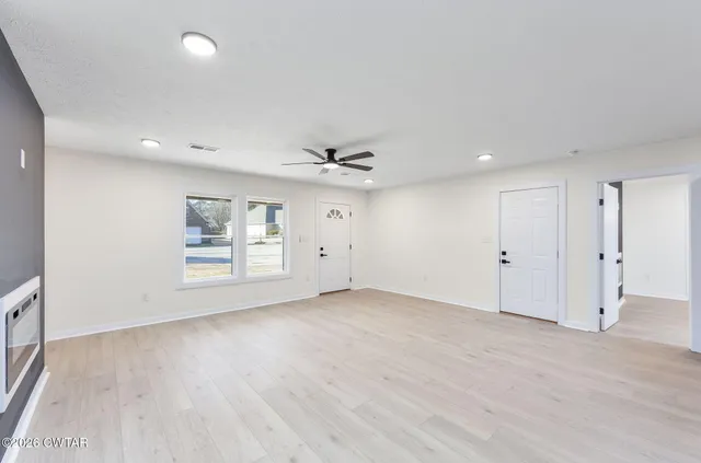 wooden floor in an empty room with a window