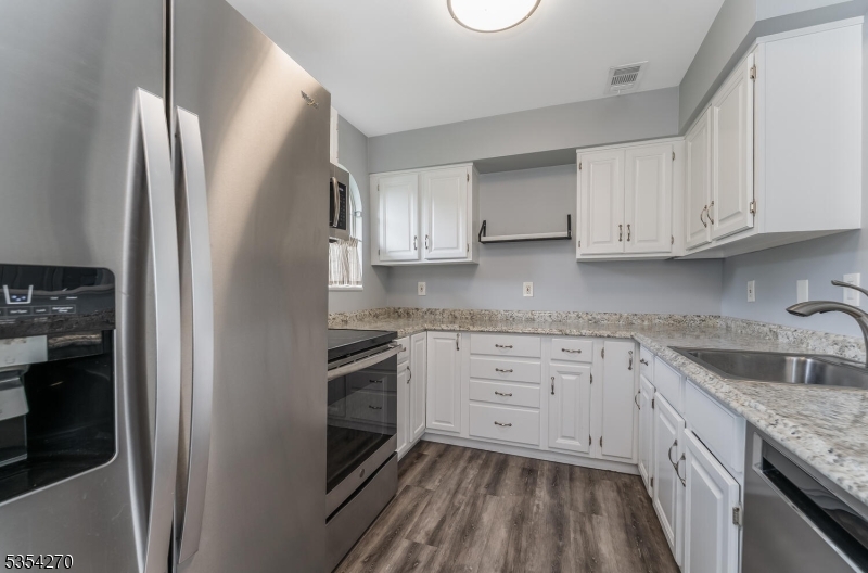 398 Terrace Lane Bedminster, NJ 07921 - Photo 12 of 31 a kitchen with granite countertop white cabinets stainless steel appliances a sink and a counter space