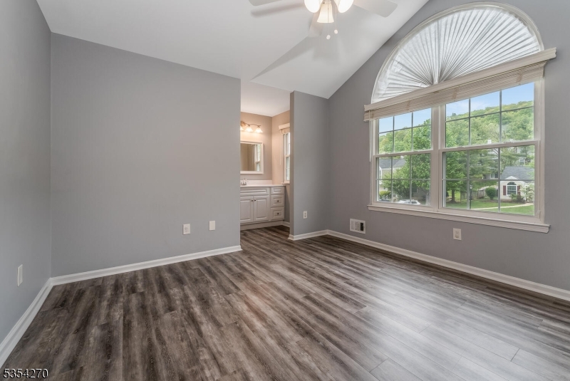 398 Terrace Lane Bedminster, NJ 07921 - Photo 18 of 31 a view of an empty room with wooden floor and a window