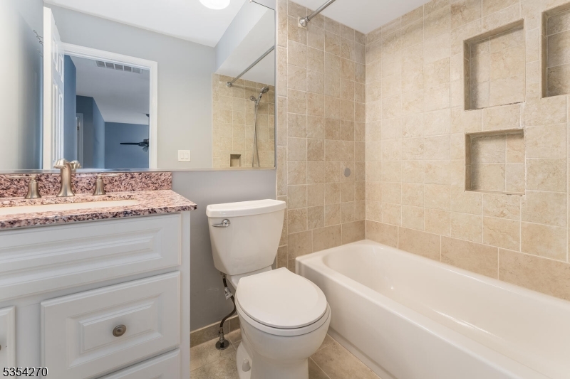 398 Terrace Lane Bedminster, NJ 07921 - Photo 24 of 31 a bathroom with a granite countertop toilet a sink and a bathtub