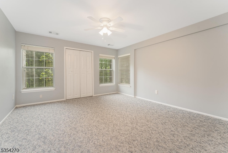 398 Terrace Lane Bedminster, NJ 07921 - Photo 25 of 31 an empty room with windows and chandelier fan