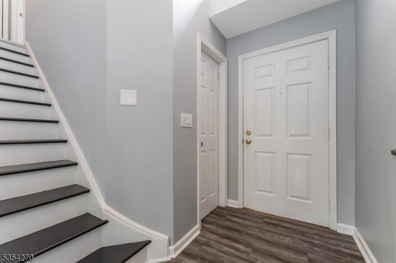 398 Terrace Lane Bedminster, NJ 07921 - Photo 4 of 31 a view of a hallway with wooden floor and entryway