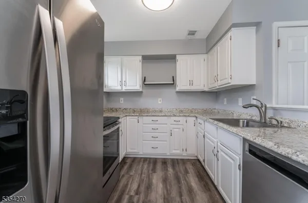 a kitchen with a sink stove and refrigerator