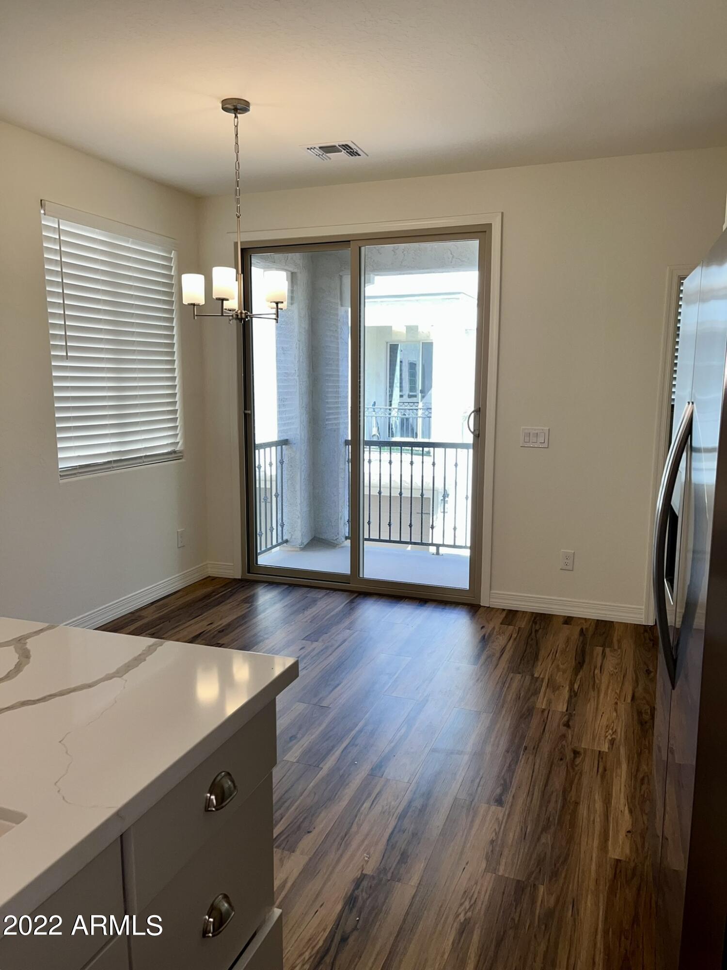 1737 East Hampton Lane Gilbert, AZ 85295 - Photo 13 of 15 an empty room with wooden floor and windows