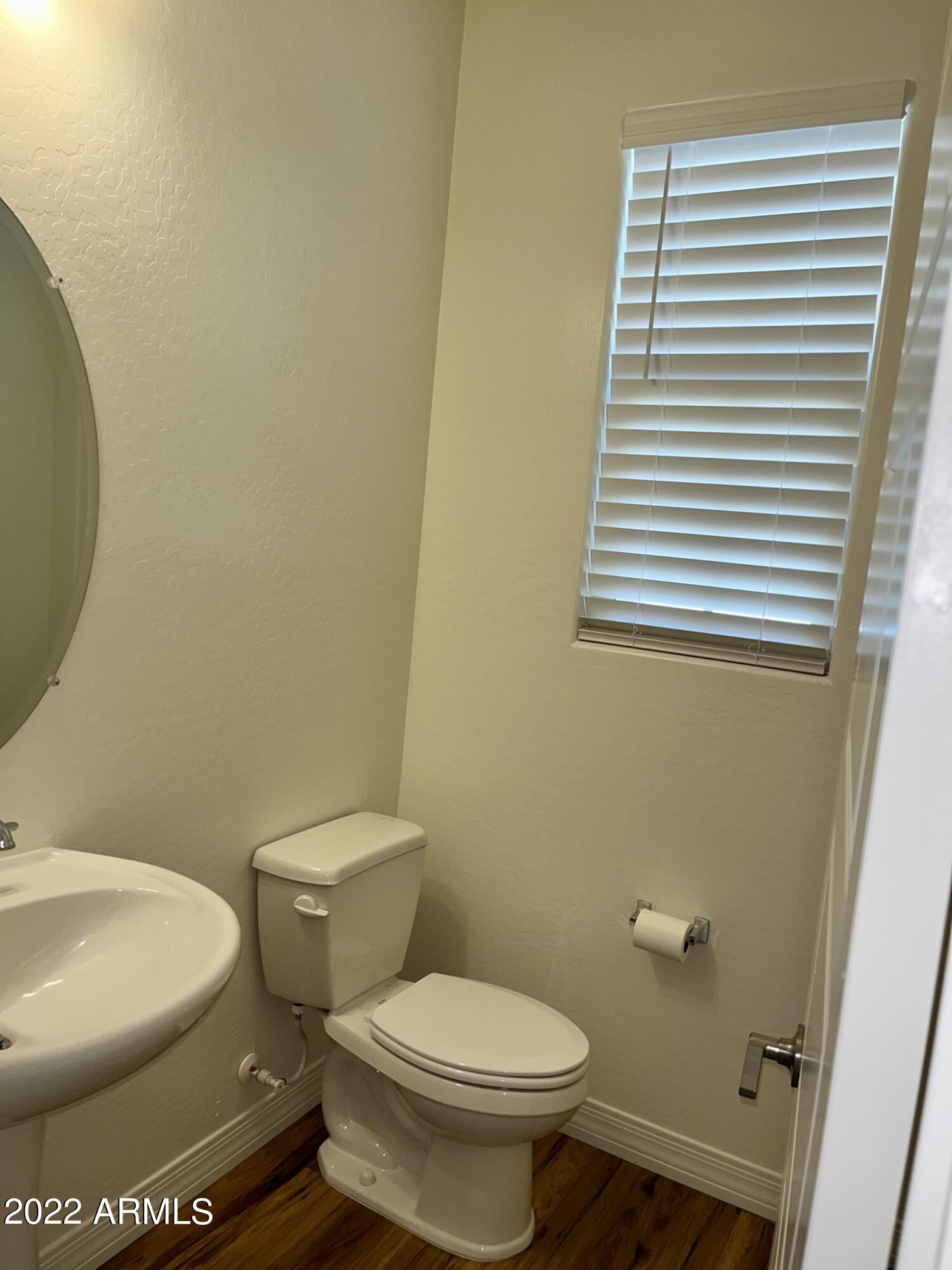 1737 East Hampton Lane Gilbert, AZ 85295 - Photo 2 of 15 a white toilet sitting next to a white sink