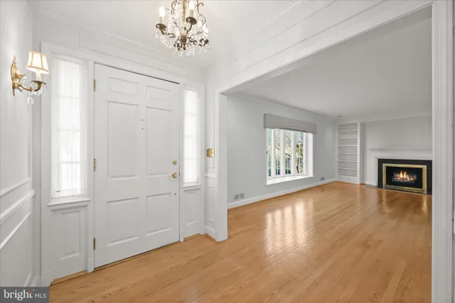 a view of empty room with wooden floor and fireplace