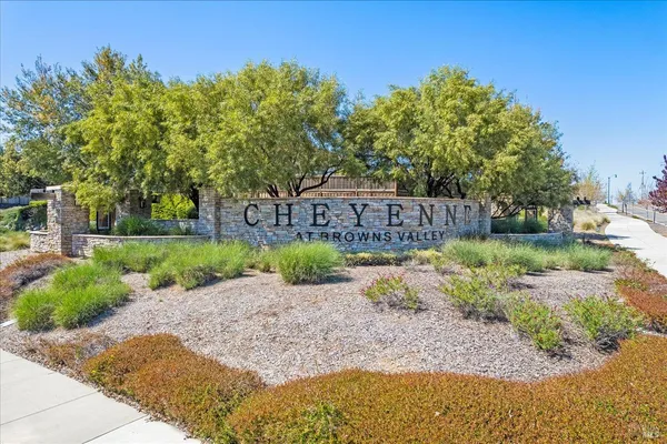 a view of a park with a bench in the background