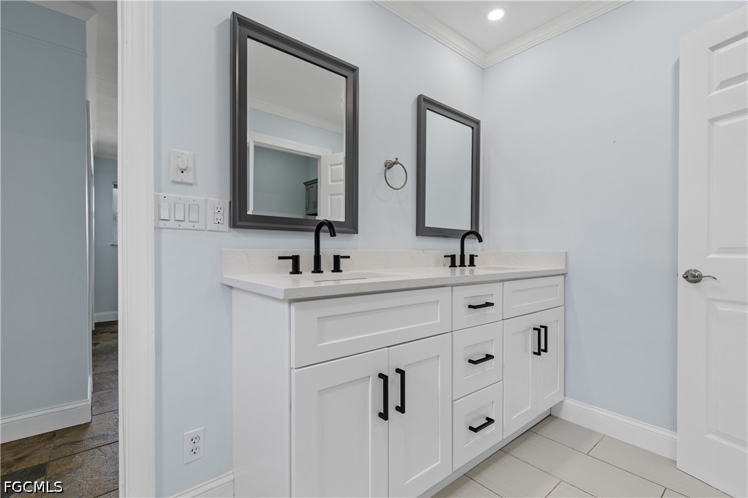416 Seaworthy Road North Fort Myers, FL 33903 - Photo 13 of 30 a bathroom with double vanity sink and mirror