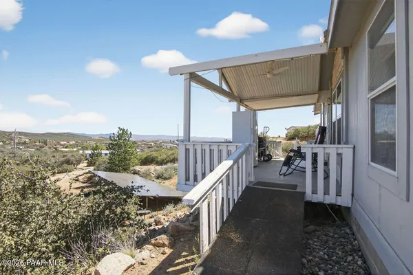 a view of a porch with furniture and wooden floor