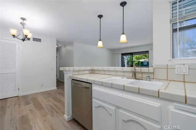 a kitchen with a sink and a wooden floor