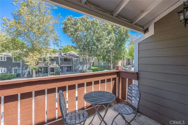 a view of a chair and table in the balcony