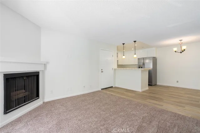 a view of a kitchen with a sink a fireplace and cabinets