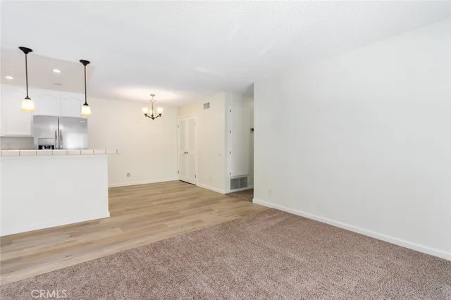 a view of a kitchen with a sink and cabinets