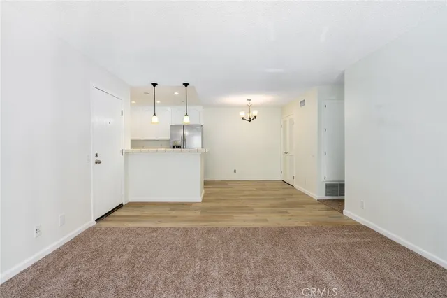 a view of a kitchen with a sink and cabinets