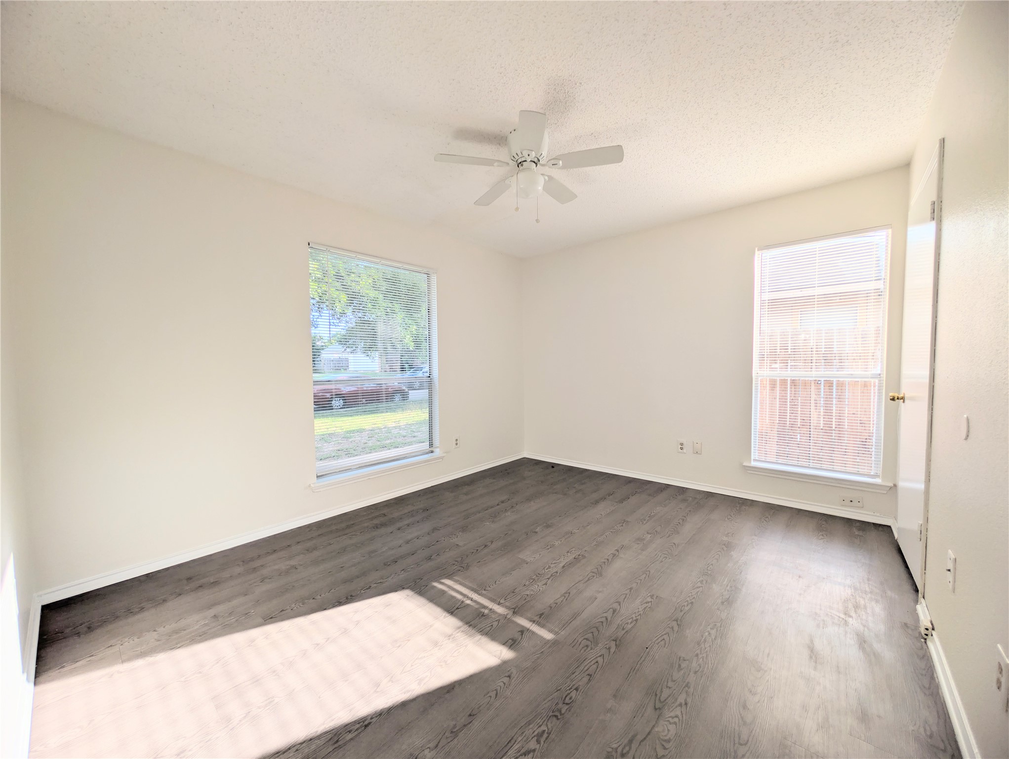 2016 Redwing Way Round Rock, TX 78664 - Photo 13 of 19 Bedroom #3:
Natural light pours into this room, highlighting the clean lines of the walls and the rich texture of the flooring.
