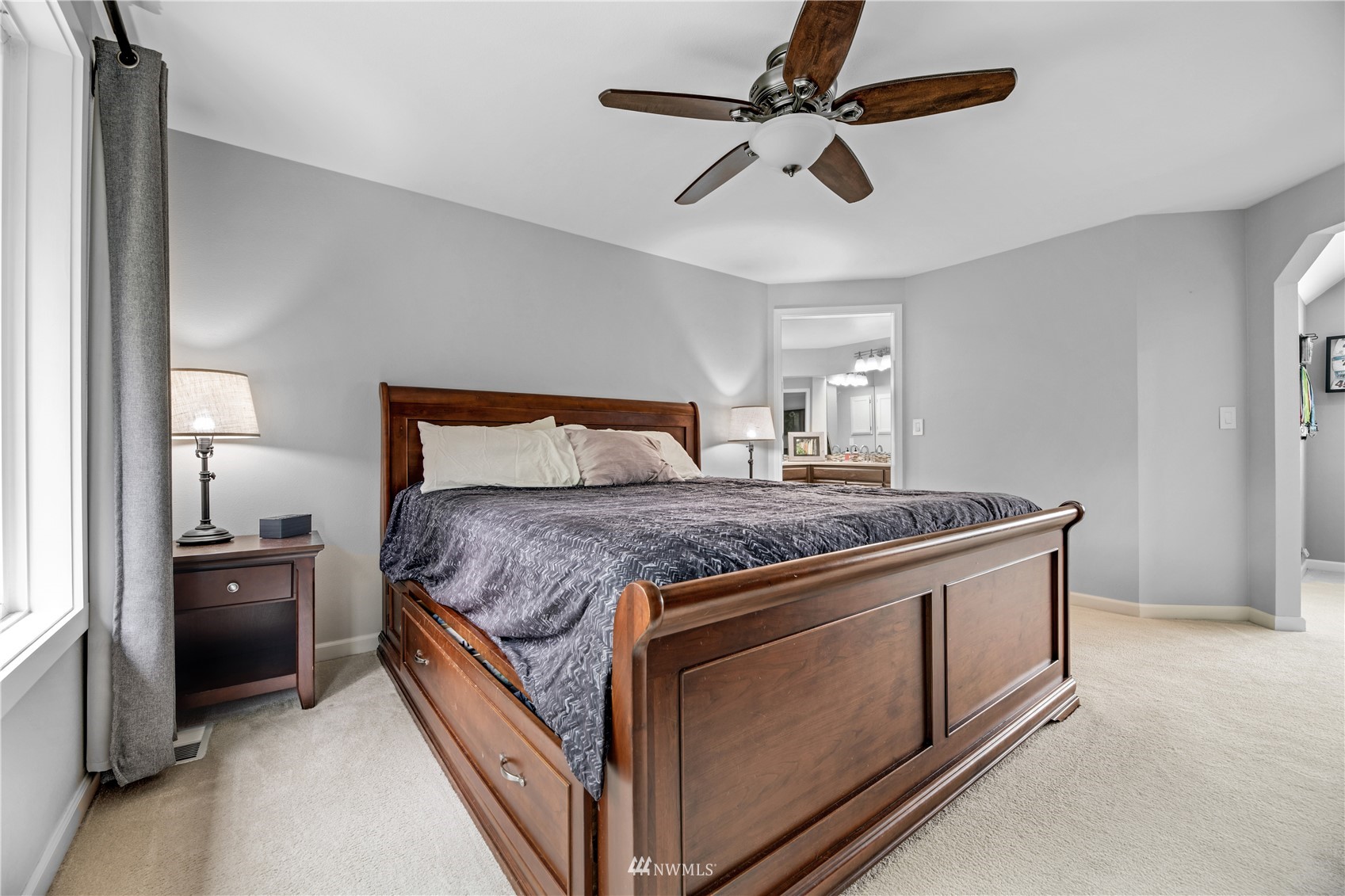 20909 33rd Avenue Southeast Bothell, WA 98021 - Photo 22 of 30 a bedroom with a bed and a ceiling fan