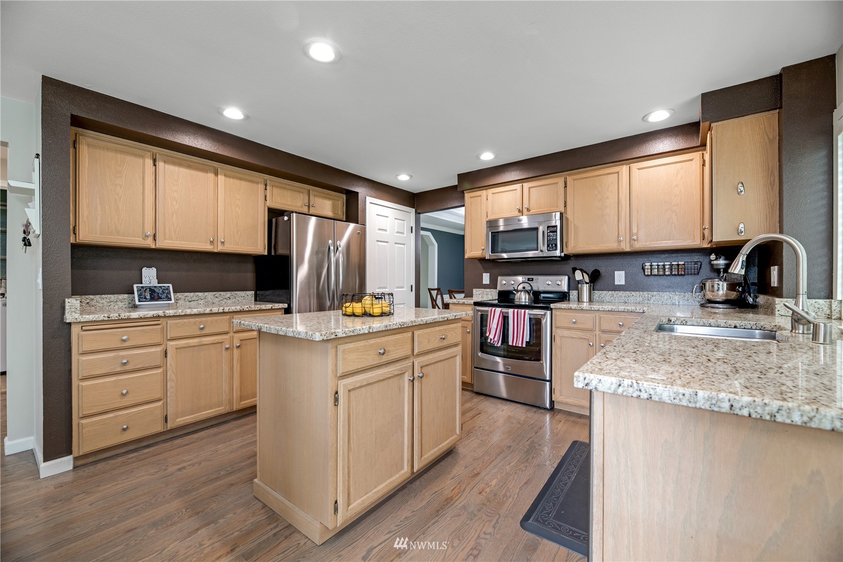 20909 33rd Avenue Southeast Bothell, WA 98021 - Photo 9 of 30 a kitchen with stainless steel appliances granite countertop a stove sink and cabinets