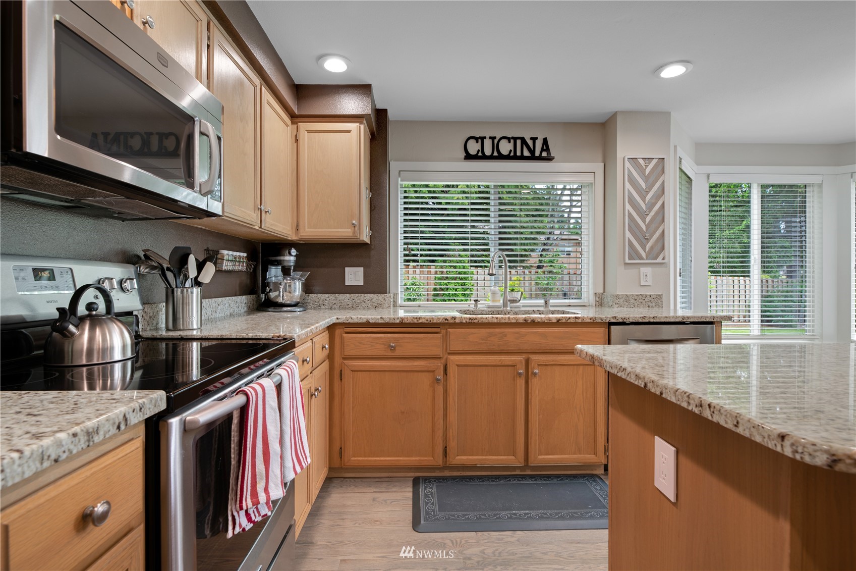 20909 33rd Avenue Southeast Bothell, WA 98021 - Photo 10 of 30 a kitchen with stainless steel appliances granite countertop a sink a stove and a microwave