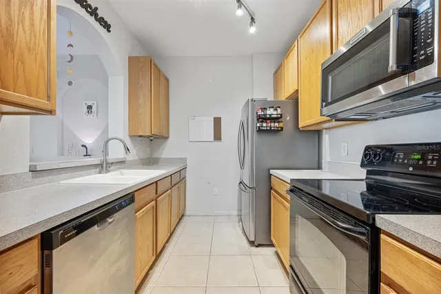 a kitchen with stainless steel appliances granite countertop a sink stove and cabinets