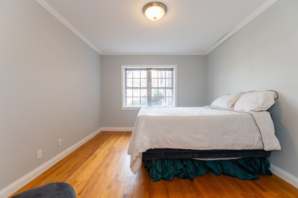 121 Lake Shore Road, Unit 2 Boston, MA 02135 - Photo 13 of 32 a bedroom with a bed and a window
