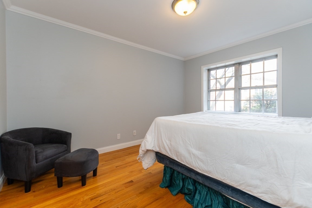 121 Lake Shore Road, Unit 2 Boston, MA 02135 - Photo 14 of 32 a bedroom with a bed and a couch