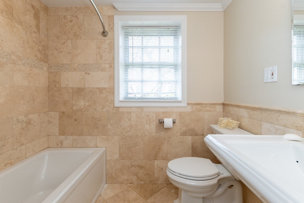 121 Lake Shore Road, Unit 2 Boston, MA 02135 - Photo 21 of 32 a bathroom with a sink a toilet and bathtub