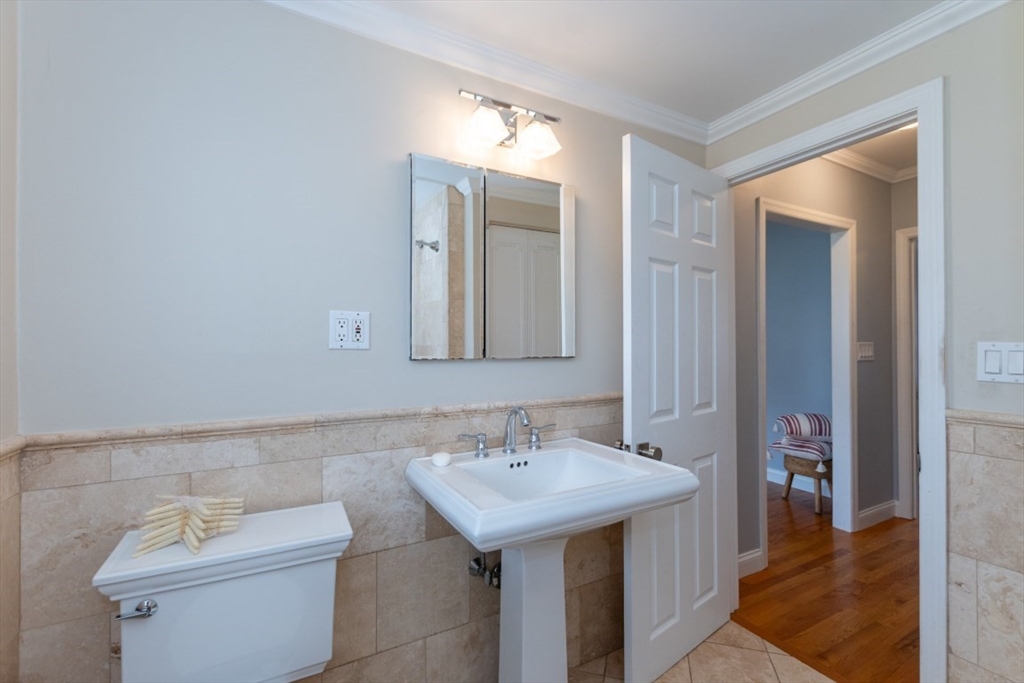121 Lake Shore Road, Unit 2 Boston, MA 02135 - Photo 23 of 32 a bathroom with a sink and a mirror