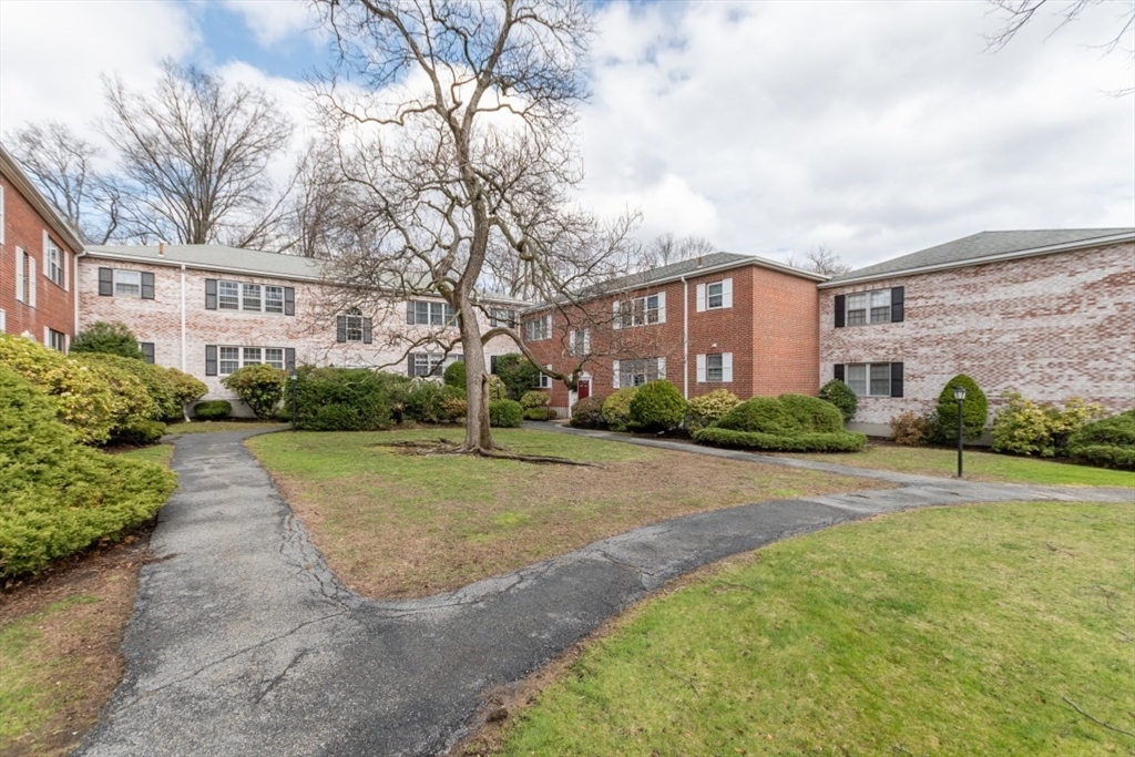 121 Lake Shore Road, Unit 2 Boston, MA 02135 - Photo 24 of 32 a view of a building with a yard