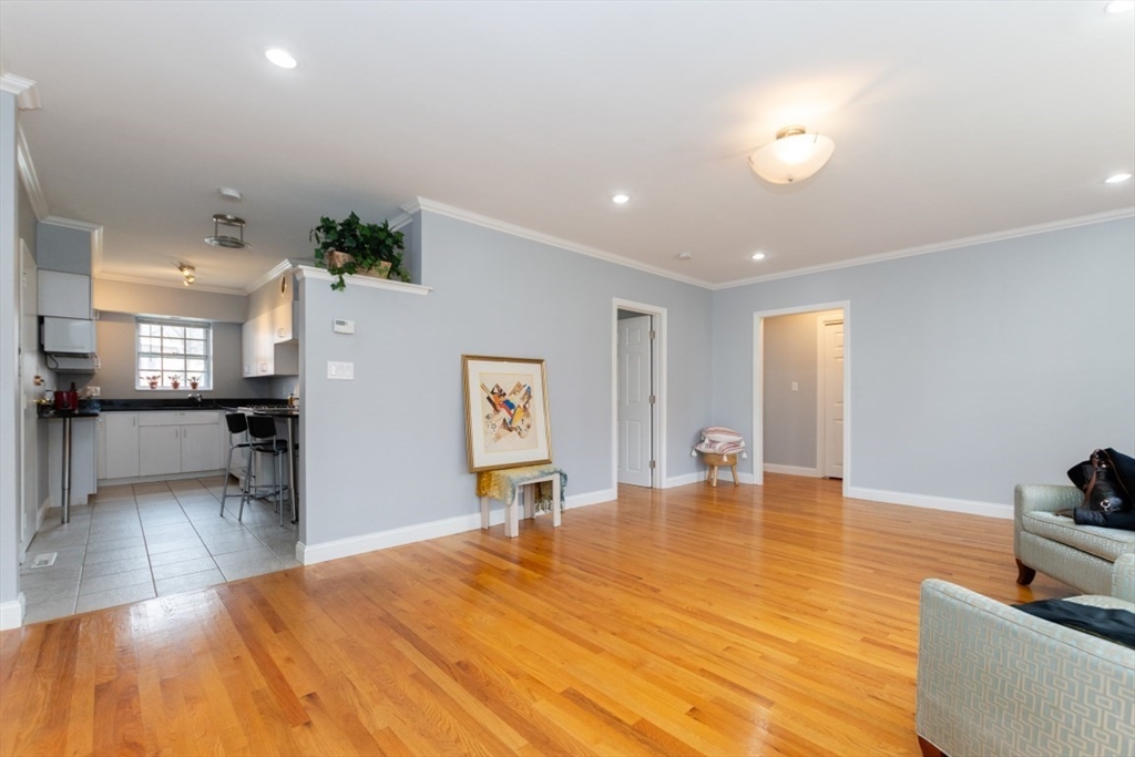 121 Lake Shore Road, Unit 2 Boston, MA 02135 - Photo 4 of 32 a room with lots of table and chairs